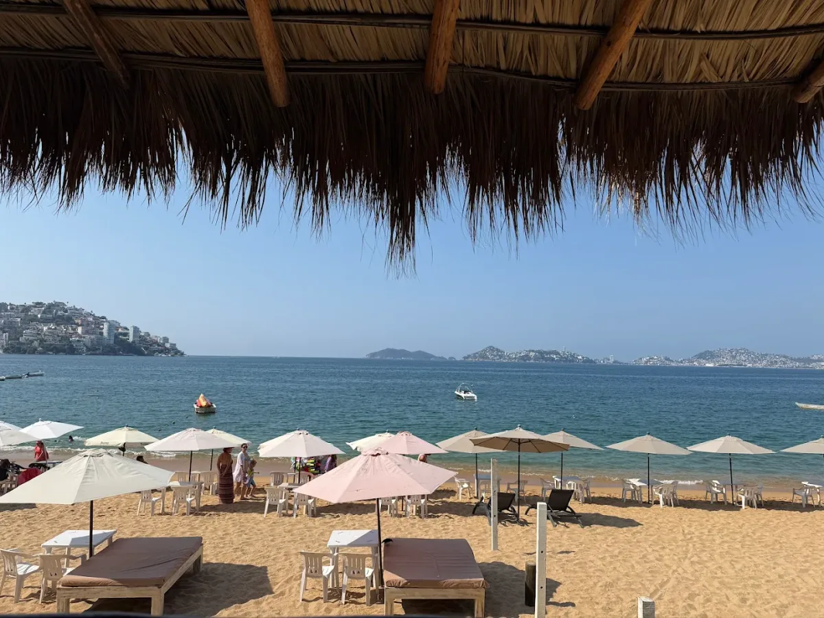 Tables with umbrellas on the sand at Lupe de Arena, Costa Azul