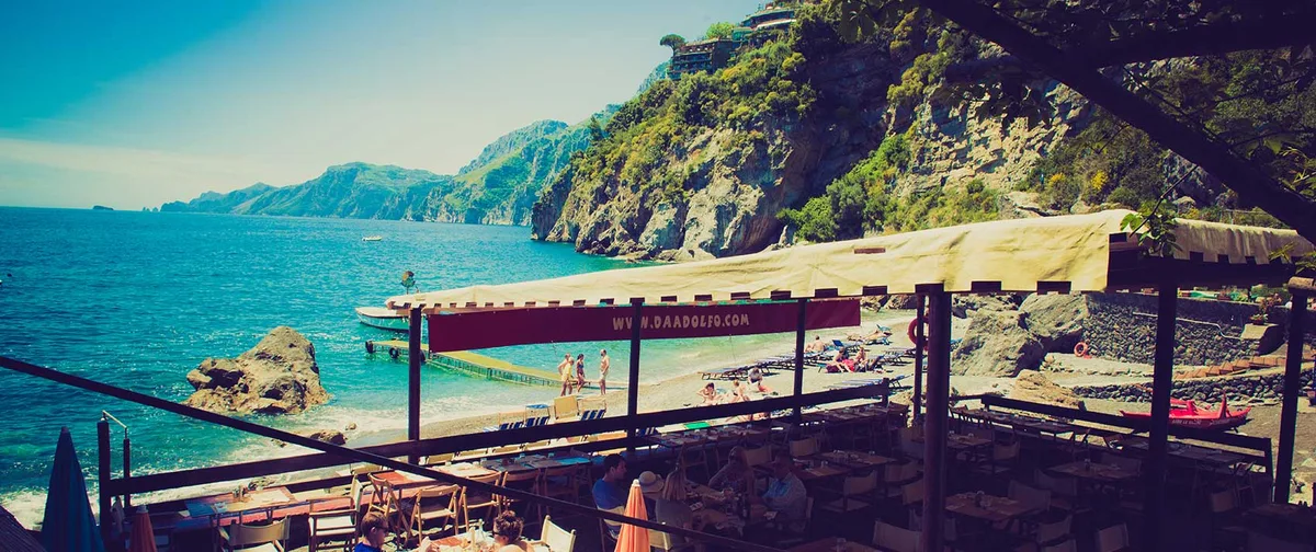 Rustic beachfront tables at Da Adolfo, Laurito Beach, Positano