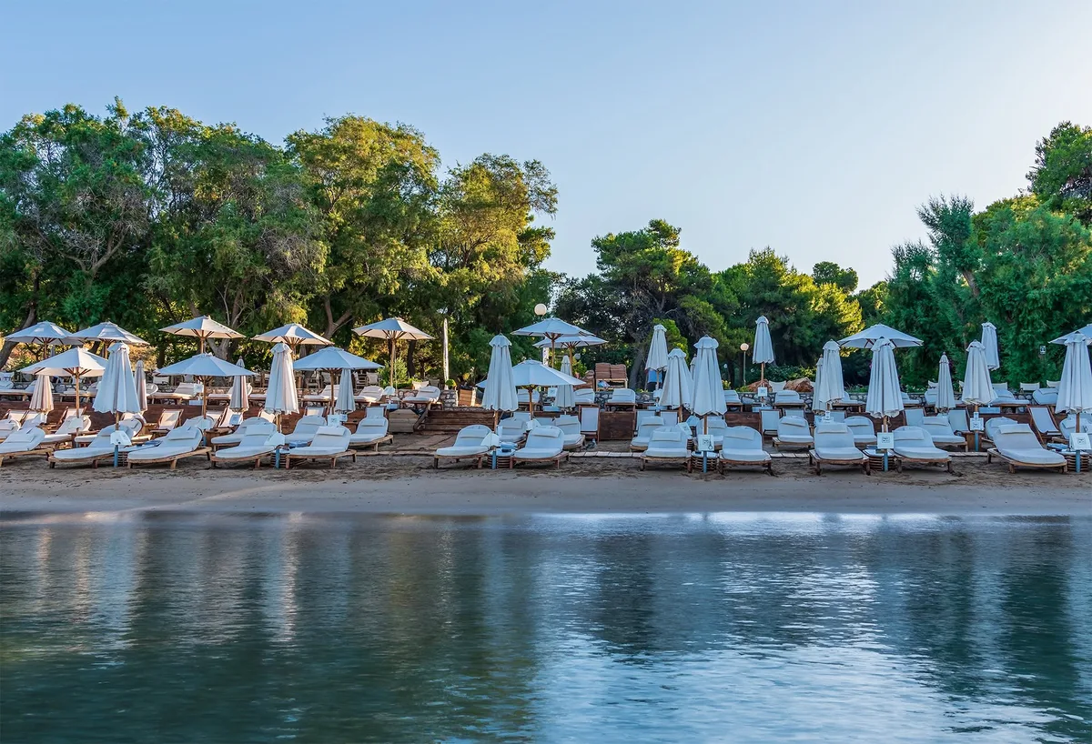 Calm water and simple sunbeds at Zen Beach, Vouliagmeni