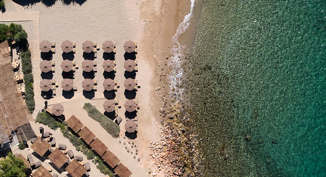 Tiered sunbed terraces in a pine bay at Krabo Beach, Kavouri