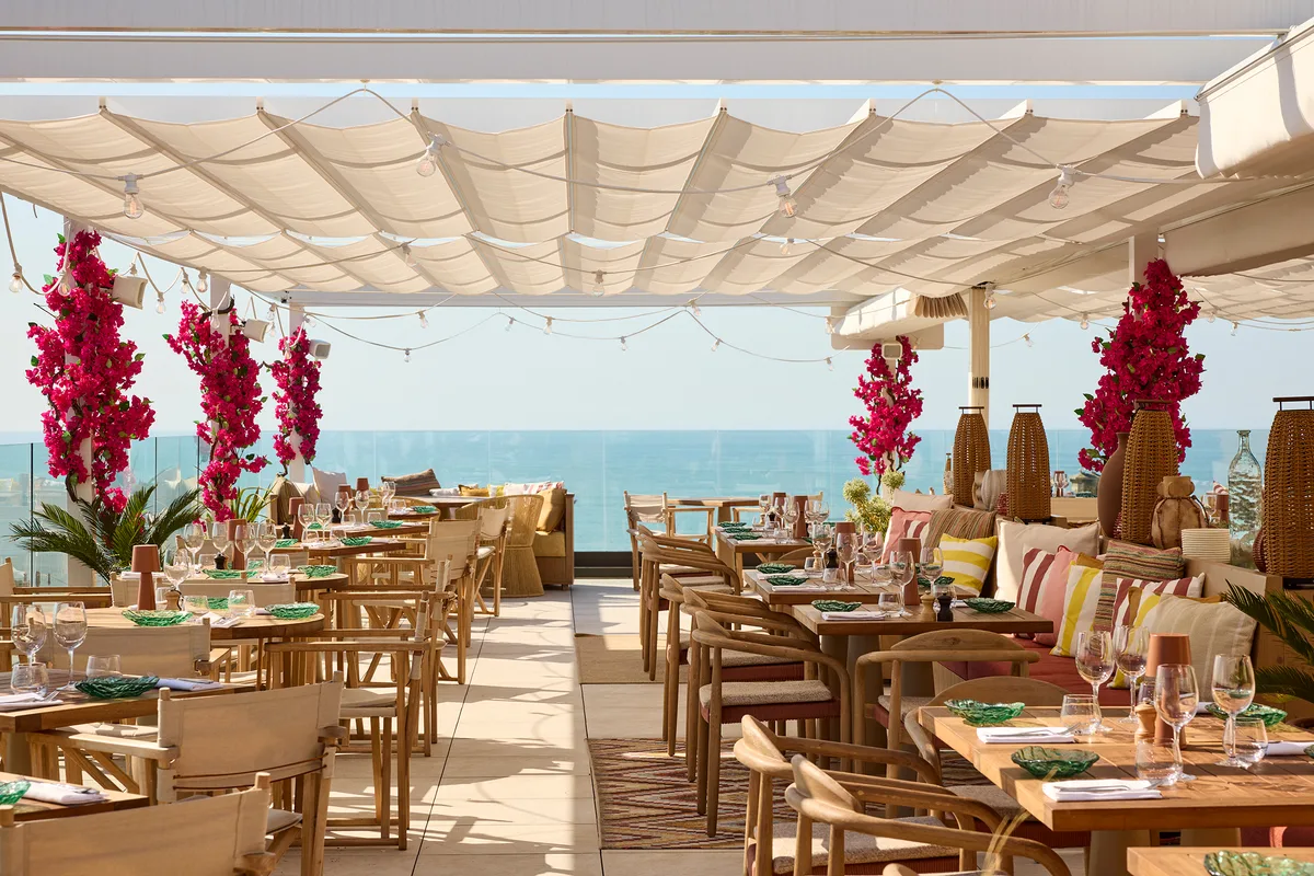 Boho-tropical beach lounge terrace at La Petite Plage facing the Cote des Basques, Biarritz