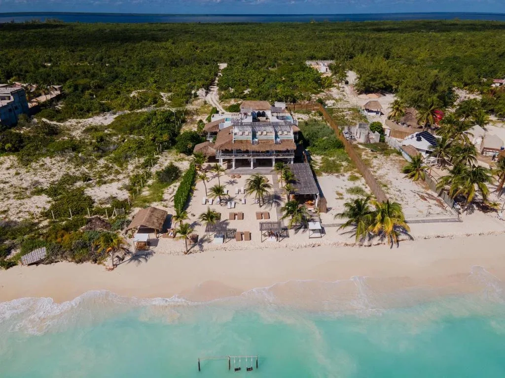 Loungers on quiet white sand at Punta Blanca Beach House, Isla Blanca