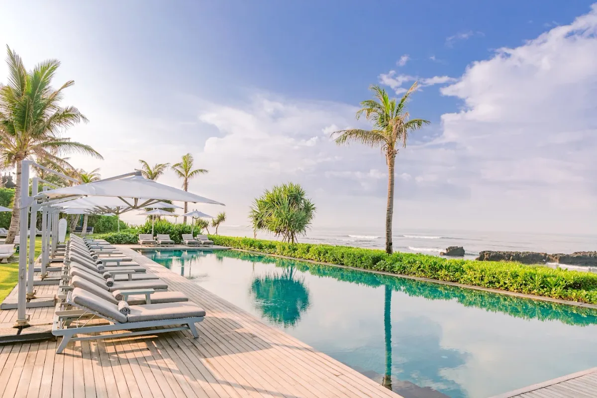 Poolside daybeds facing the sand at COMO Beach Club, Echo Beach