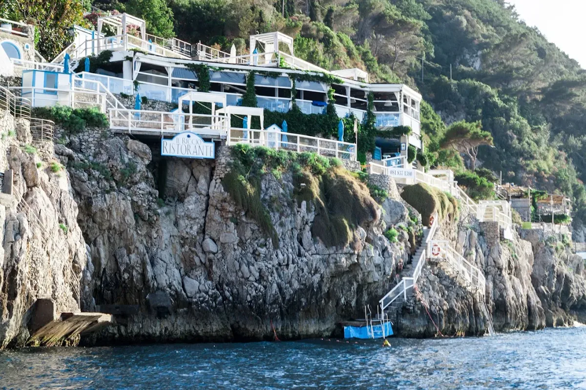 Whitewashed terrace and sun loungers on the rocks near the Blue Grotto at Il Riccio, Anacapri