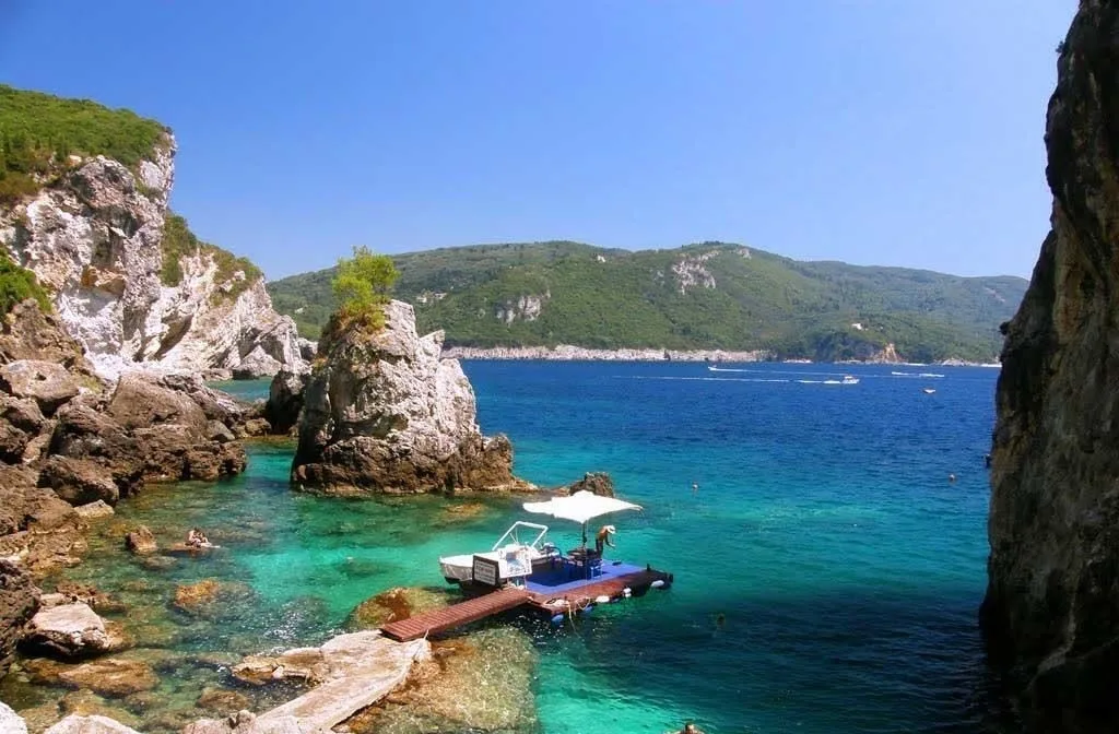 Cliff cove swimming and a rock-built bar at La Grotta, Paleokastritsa