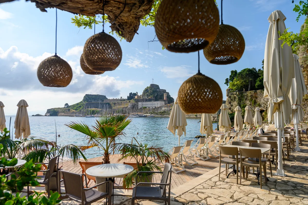 Loungers facing the Old Fortress at Imabari Corfu, Faliraki Beach