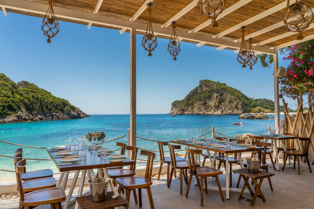 Luxury sunbeds and a small pool above the sea at Akron Beach Bar, Agia Triada