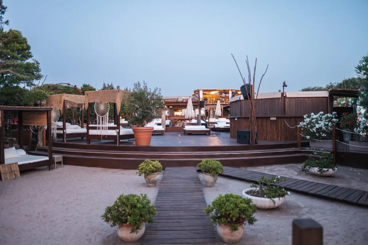 Sunbeds and private cabanas on pale sand at Vesper Beach Club, Capriccioli