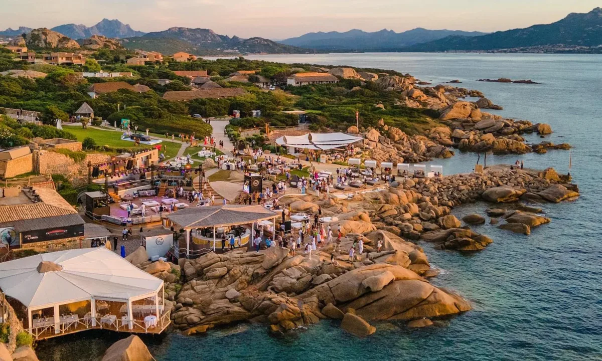 Sunset DJ terrace built into the granite fort at Phi Beach, Baja Sardinia