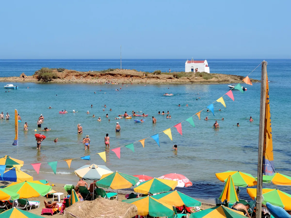 Shallow water and soft sand at Dolphin Beach Bar, Malia