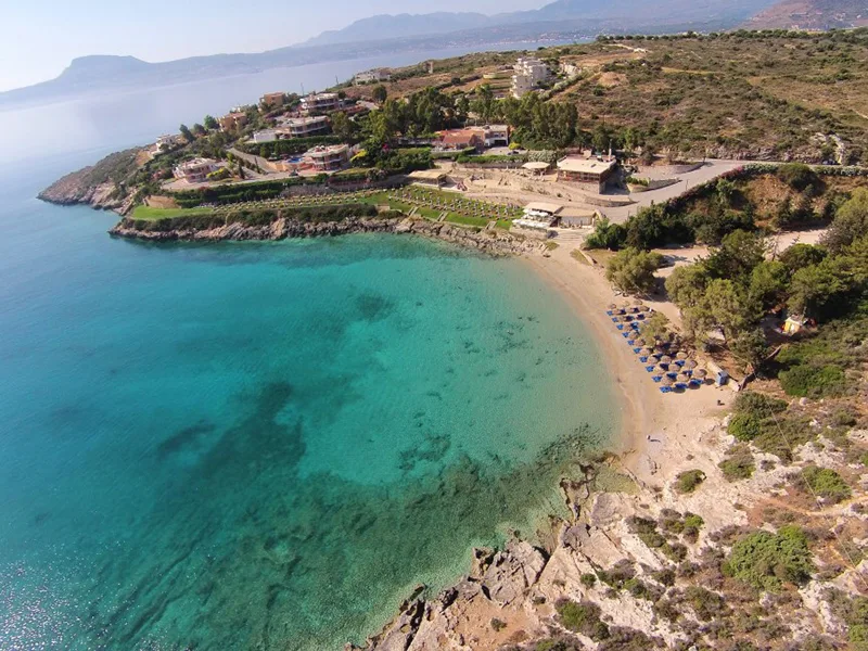 Sunbeds above a calm cove at Loutraki, Marathi Bay