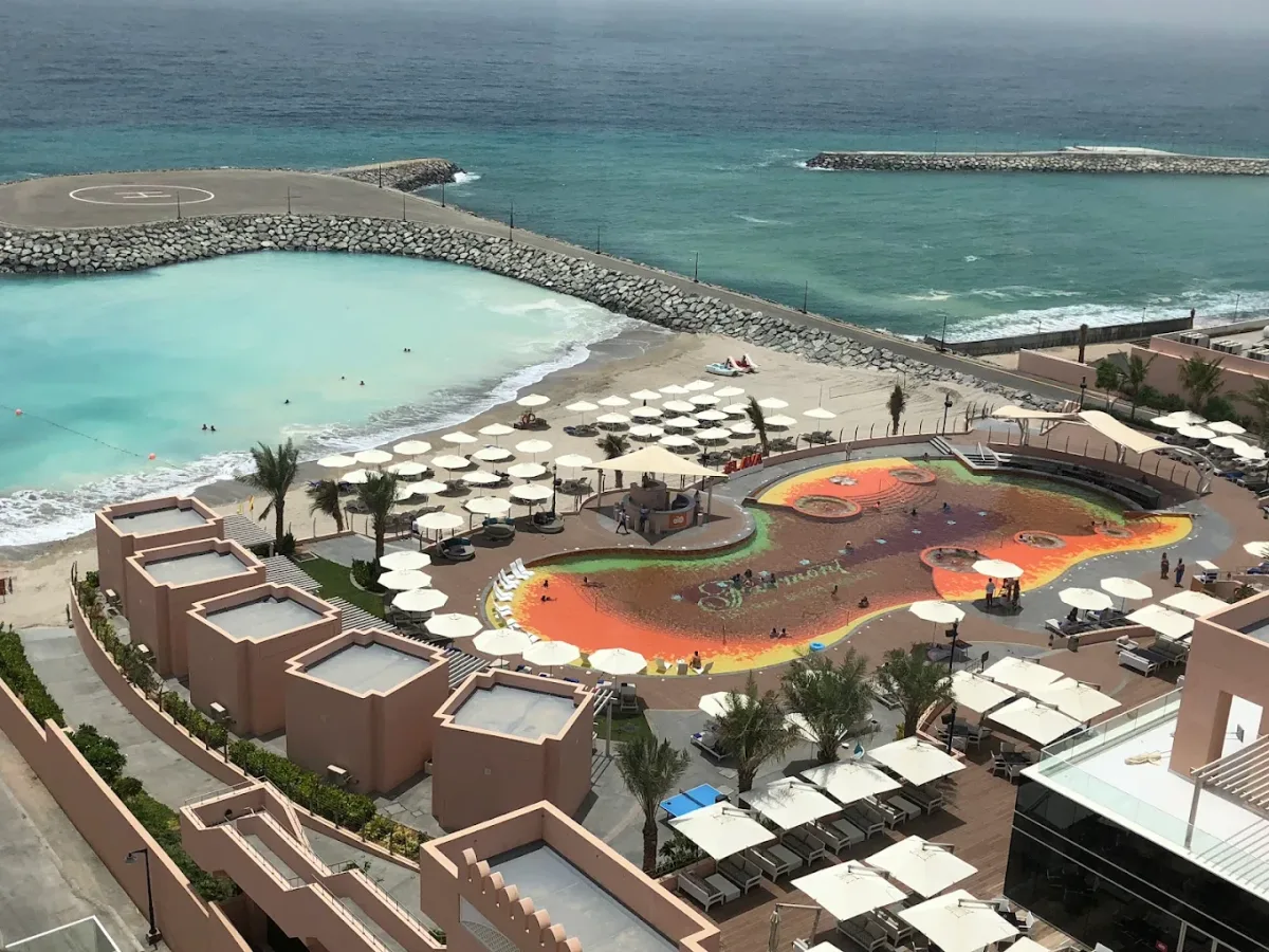 Free-form lava-tiled pool and day beds at Lava Beach Club, Mina Al Fajer, Dibba