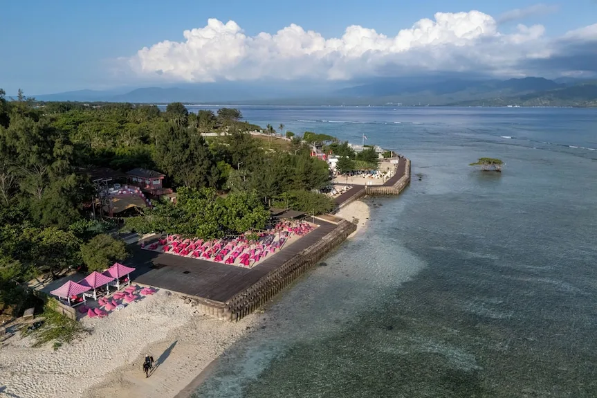 Pink bean bags around the lap pool at PinkCoco adults-only beach club, Gili Trawangan