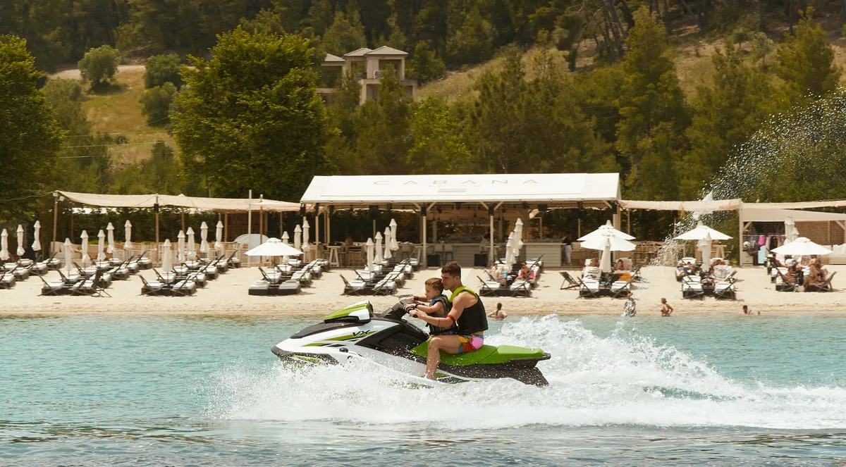 Party crowd and sunbeds on the Blue Flag beach at Cabana Beach Club, Paliouri