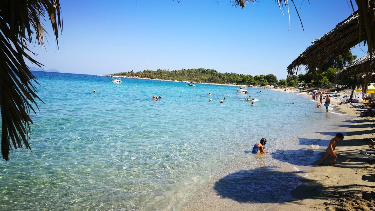 Shaded loungers by the lagoon port at Glarokavos Beach Bar, Pefkohori