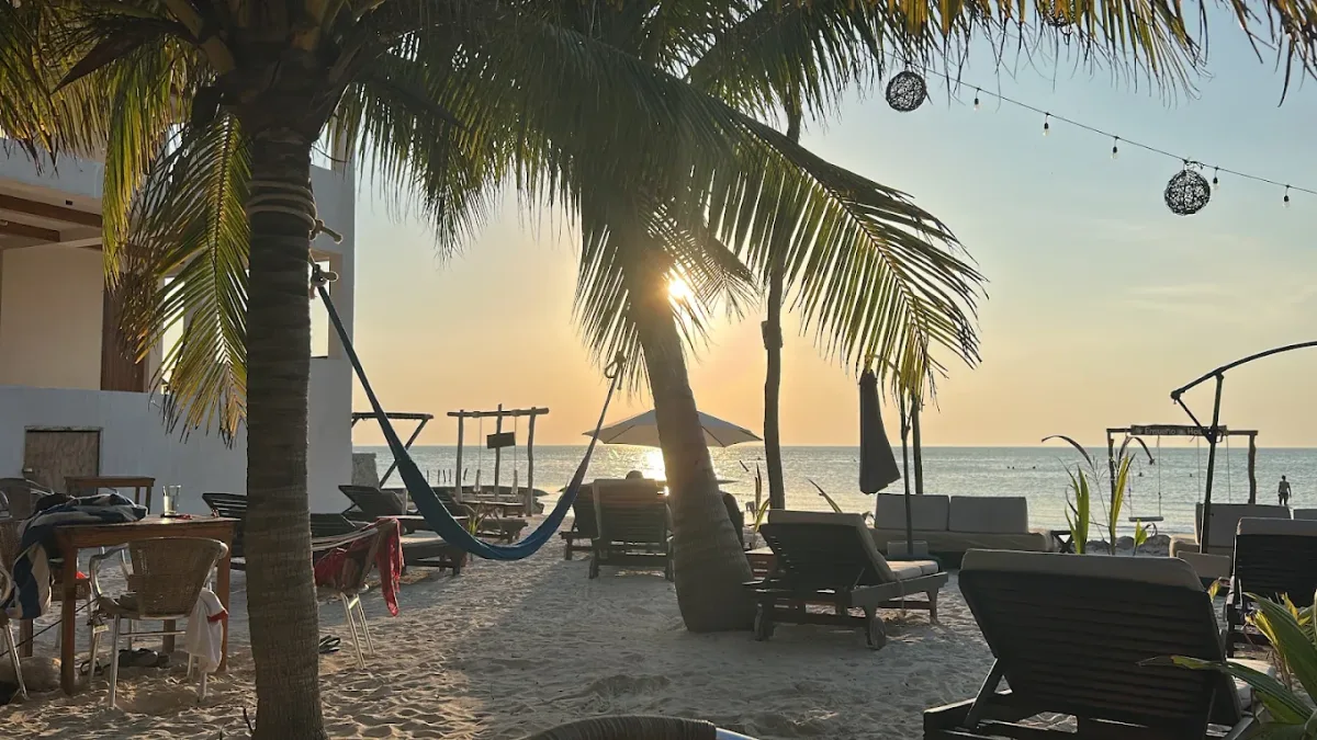 Hammocks and swings over the water at Carolinda Beach Club, toward Punta Cocos