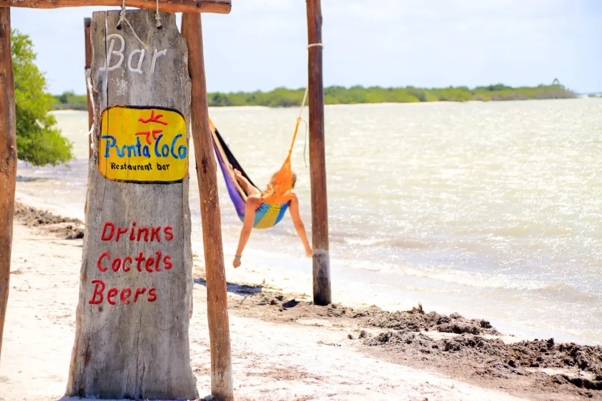 Pier and colourful hammocks at sunset at Punta Coco, Playa Punta Cocos