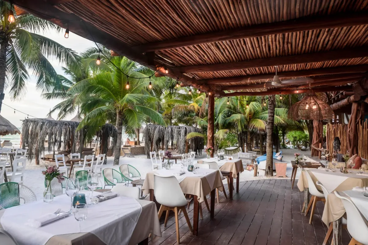 Wooden loungers and macrame hammocks on the sand at Mandarina Beach Club, Casa Las Tortugas