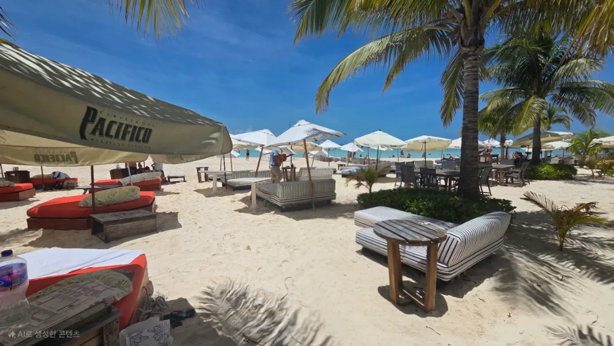 Beach beds and cabanas steps from the water at Oceanus Beach Club, Playa Norte