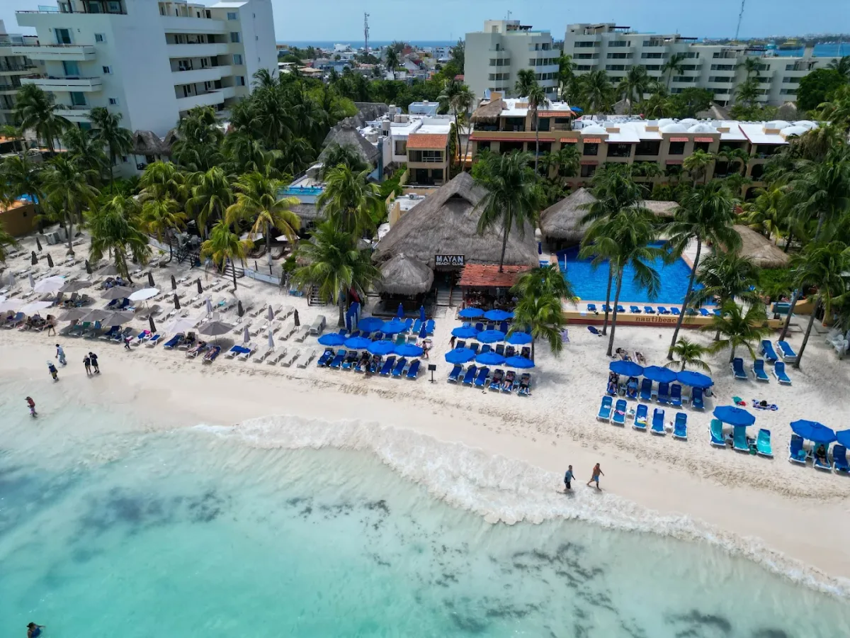 Palapa loungers and a two-level pool at Mayan Beach Club, Playa Norte