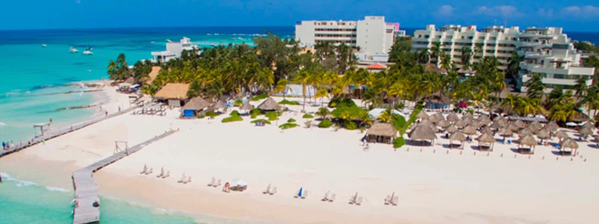 Palapas, hammocks and swings on the white sand at Playa Norte Beach Club
