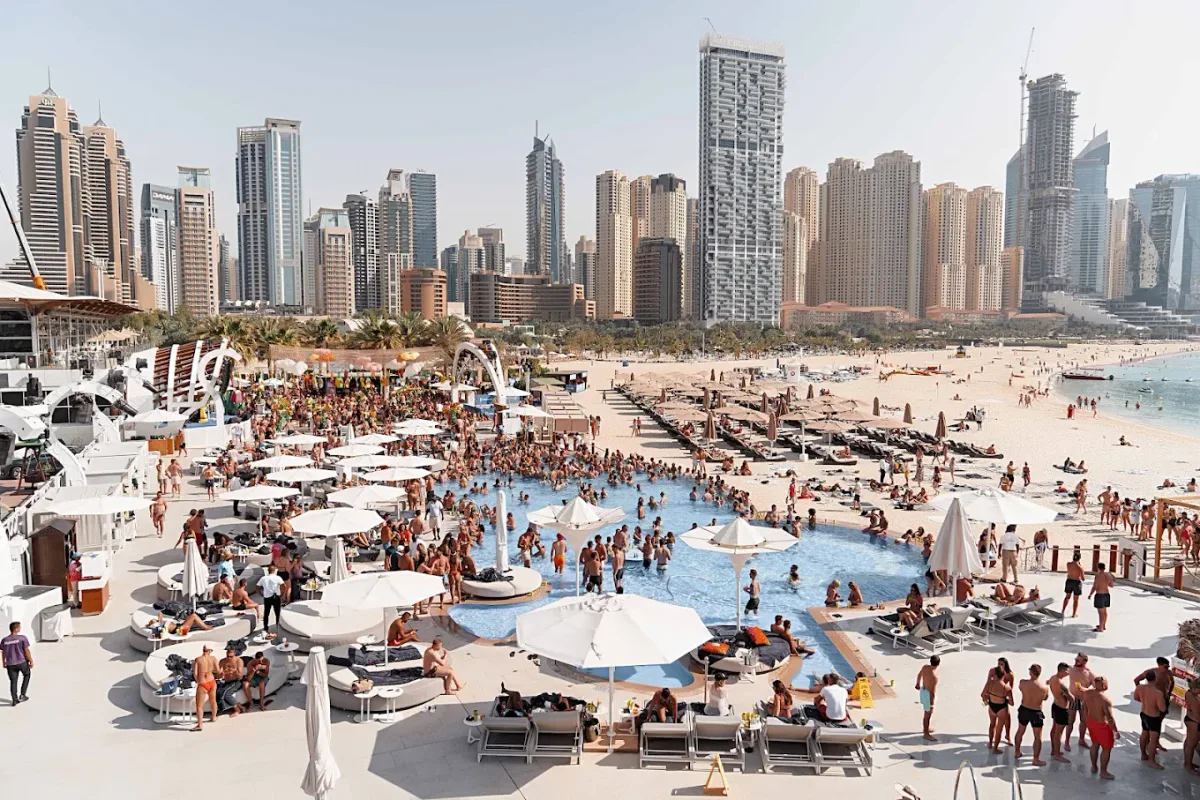 Glass-walled pool and beach club stage by Skydive Dubai at Zero Gravity, Marina end of JBR