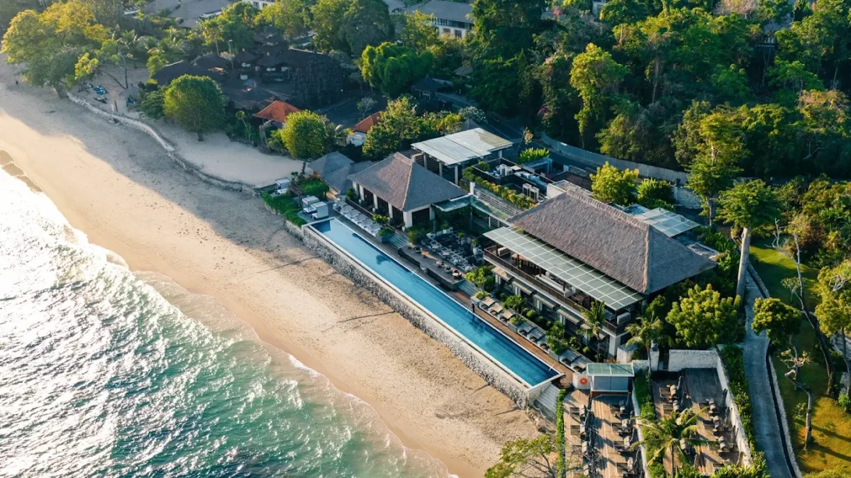 Beachfront pool and sunset daybeds at Sundara Beach Club, Jimbaran Bay