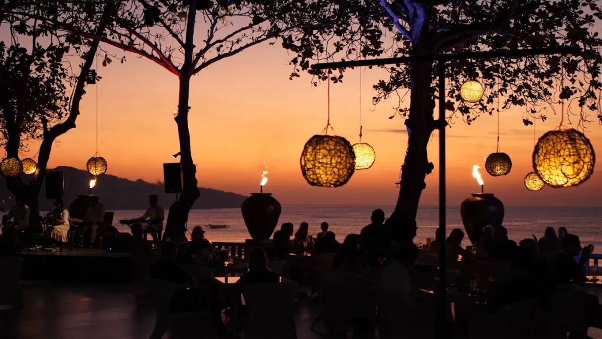 Palm-shaded beach tables at Sunset Beach Bar and Grill, Jimbaran Bay
