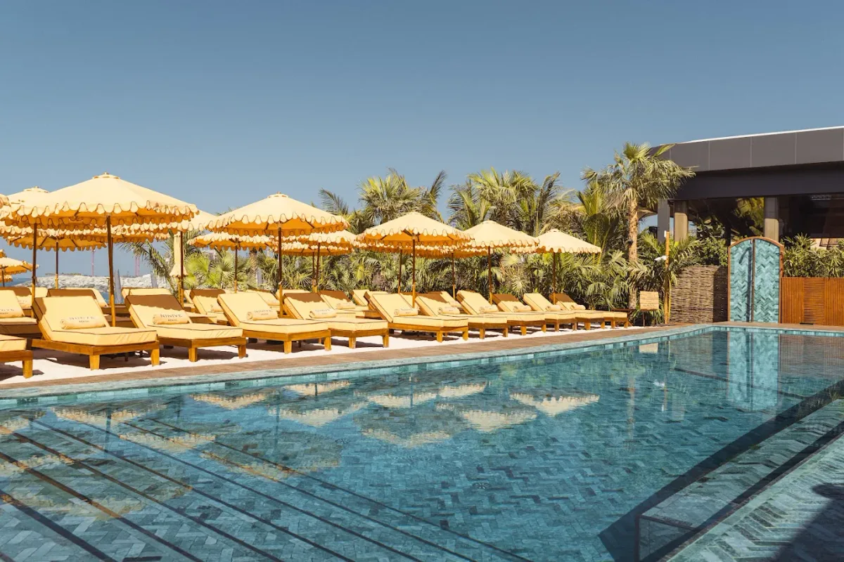 Turquoise-tiled pool and Moroccan cabanas at Ninive Beach, J1 Beach