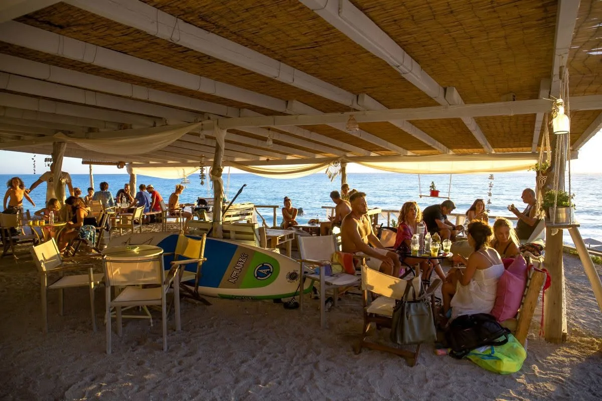 Loungers and couches on the sand at Fresco Canteen, Gialos Beach