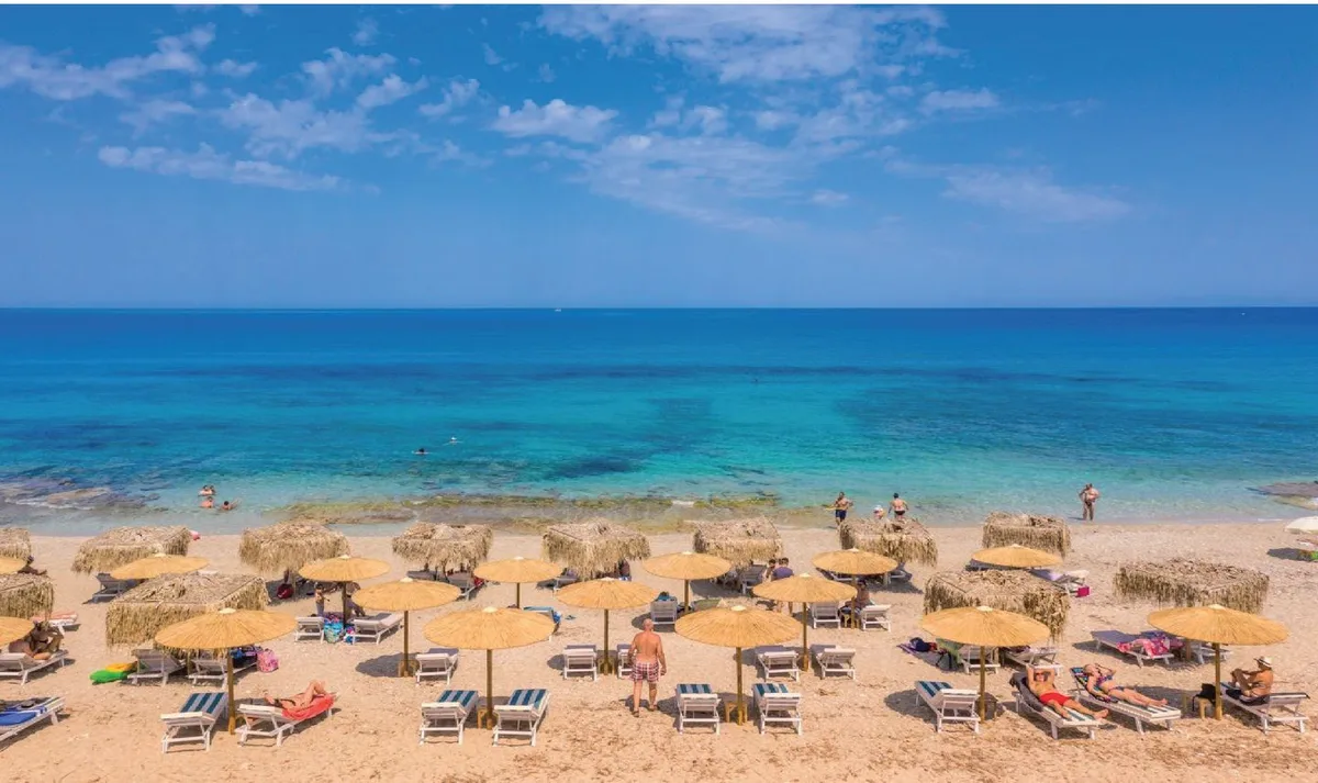 Reed umbrellas and beachfront tables at Varko Summer Bar Resto, Agios Ioannis Beach