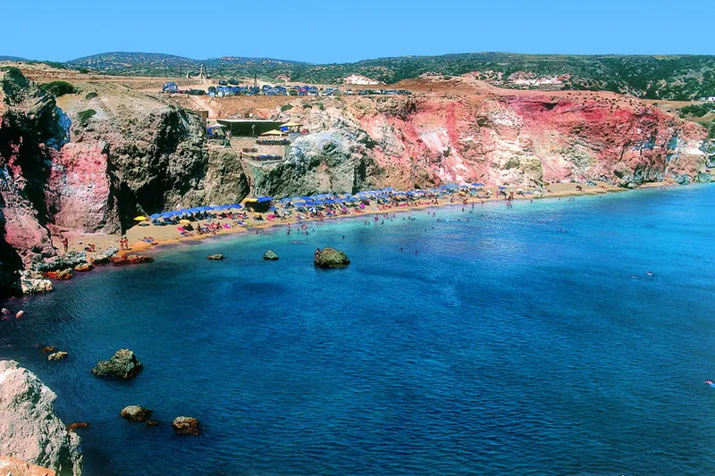 Multi-level bar built into the red cliffs at Deep Blue Beach Bar, Paliochori Beach