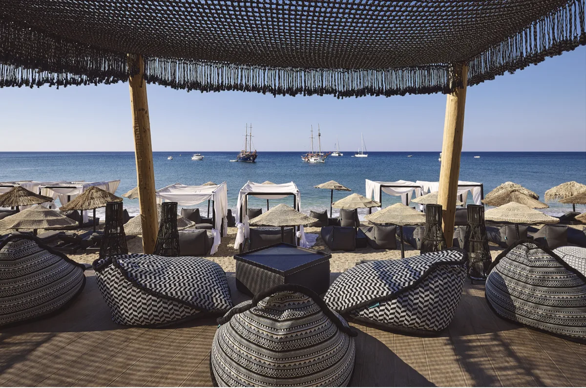 Sunbeds and straw umbrellas by the sea at Aqua Loca Beach Bar, Paliochori Beach