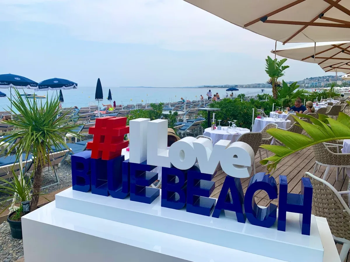 Cushioned loungers and grilled fish service on the deck at Blue Beach, central Nice