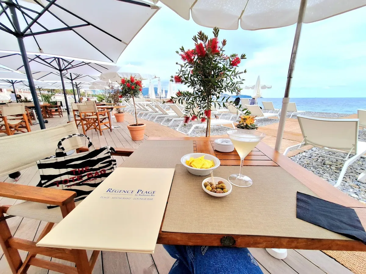 Loungers and a Mediterranean restaurant facing the bay at Régence Plage, western Nice