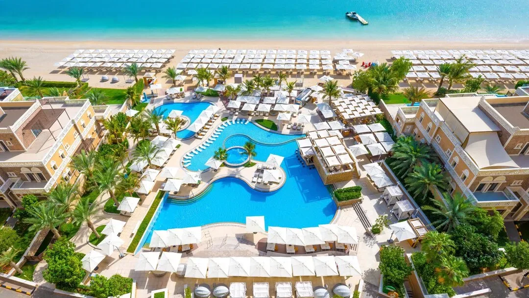 Family pool with raised jacuzzi and kids' pool at Soluna Beach Club, Balqis Residences