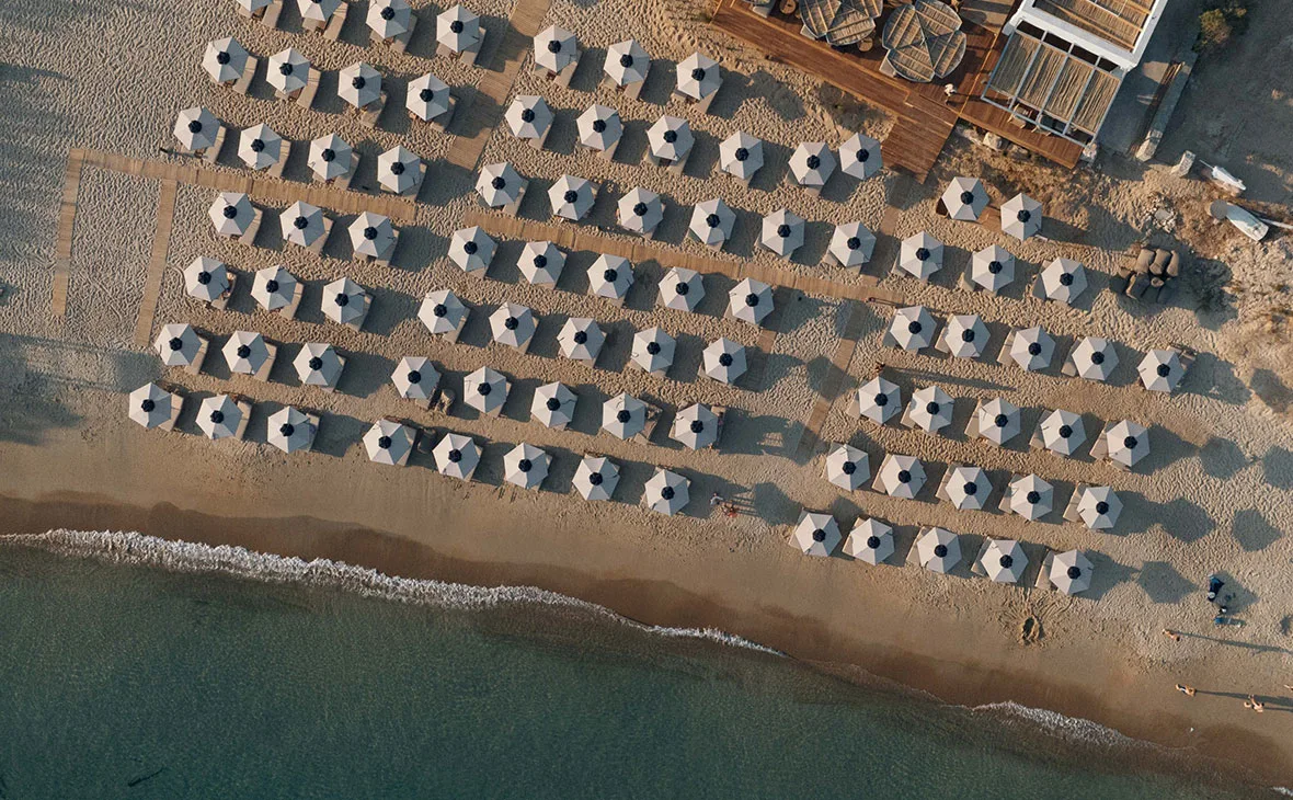 Sunset dining and loungers at Crios Beach Bar, across the bay from Parikia