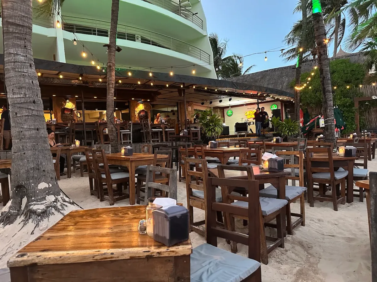 Loungers and a live-music stage on the sand at Zenzi Beach Club, Calle 10
