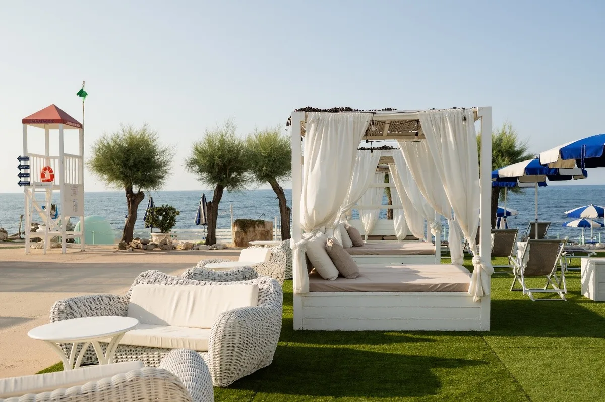 Two pools and lounger rows on a natural cove at Riva del Sole, Giovinazzo