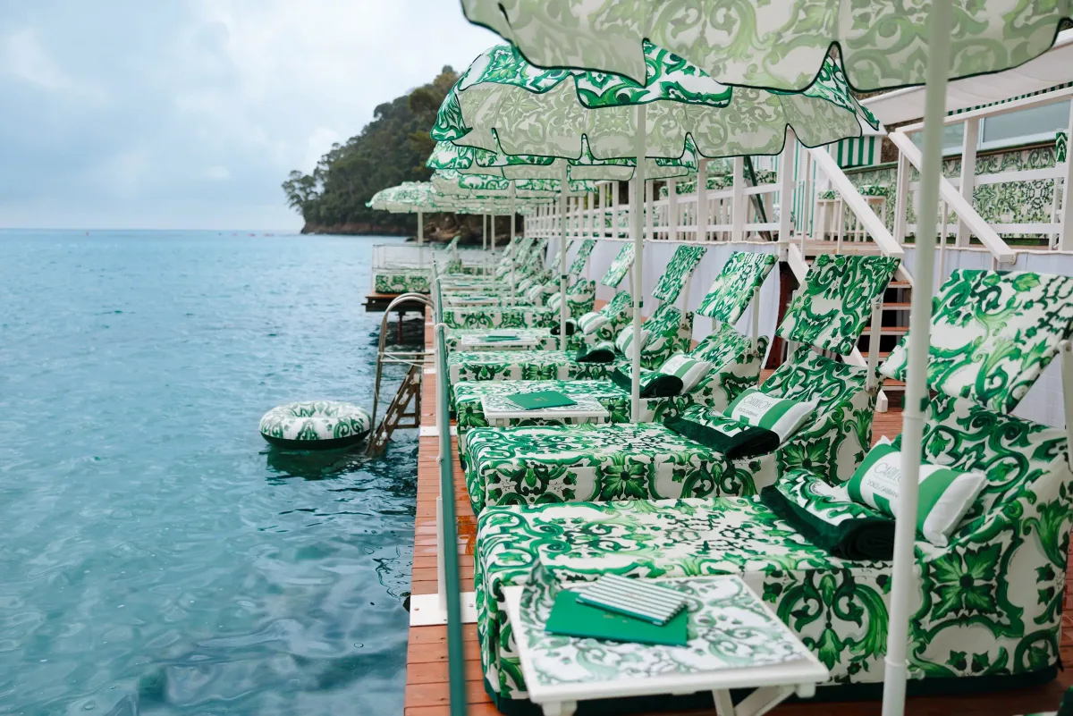 Teak deck and loungers over the water at Le Carillon, Baia di Paraggi