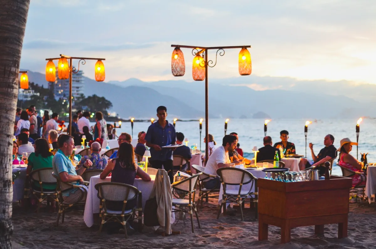 Beachfront loungers and seafood service at El Dorado Beach Club, Los Muertos Beach