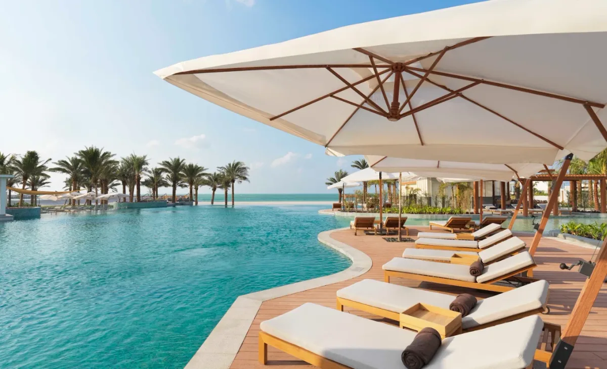 Infinity pool and white-sand beach at InterContinental Mina Al Arab