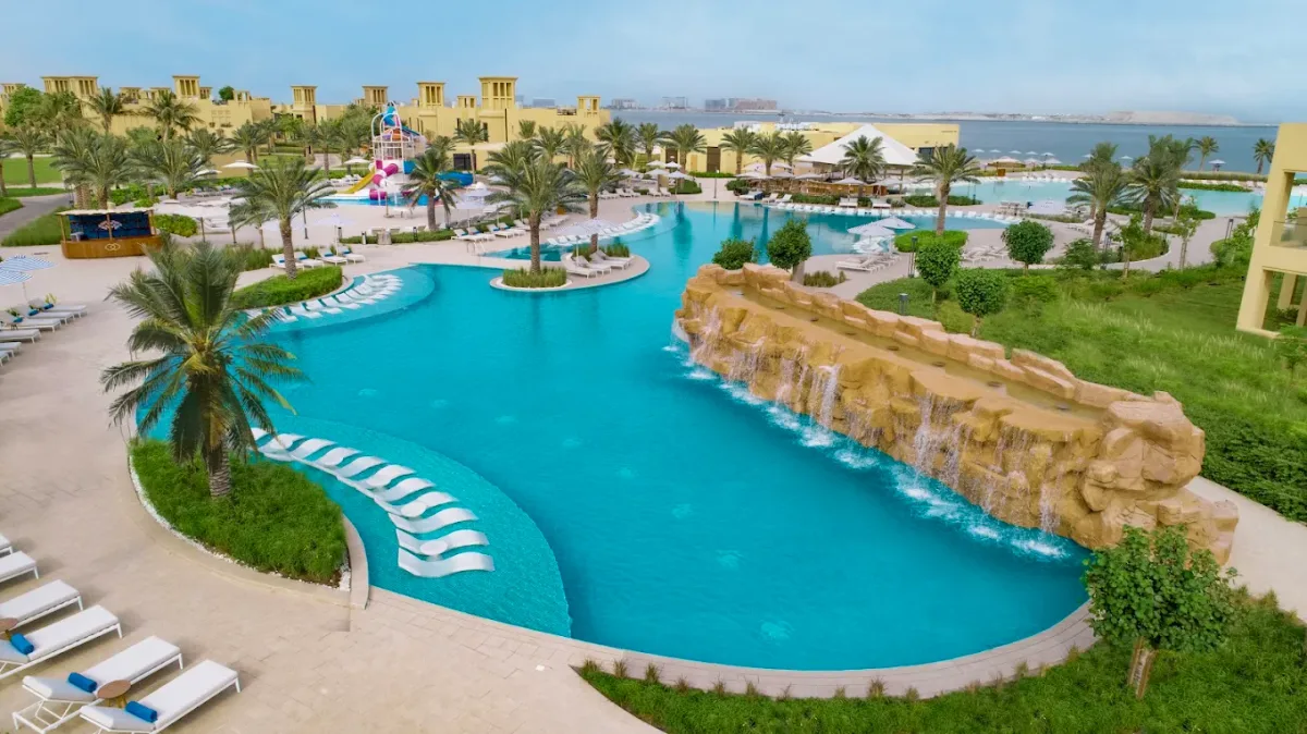Large lagoon pool and beachfront loungers at Sofitel Al Hamra Beach Resort, Al Hamra