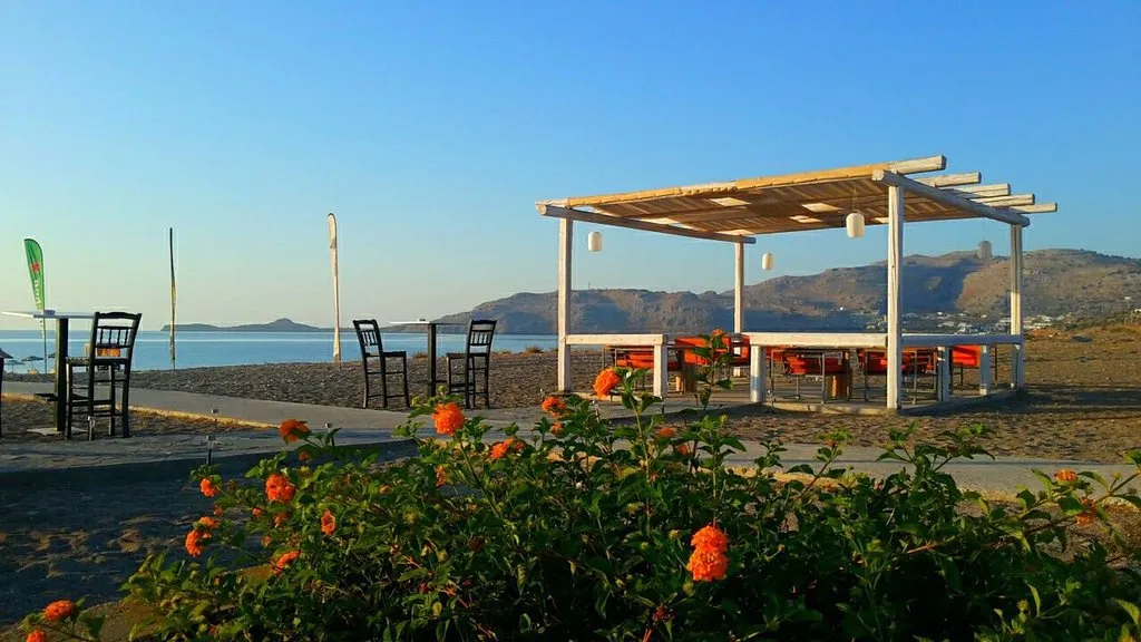Calm family shoreline and umbrellas at Ostria Beach Bar, Kalathos near Lindos