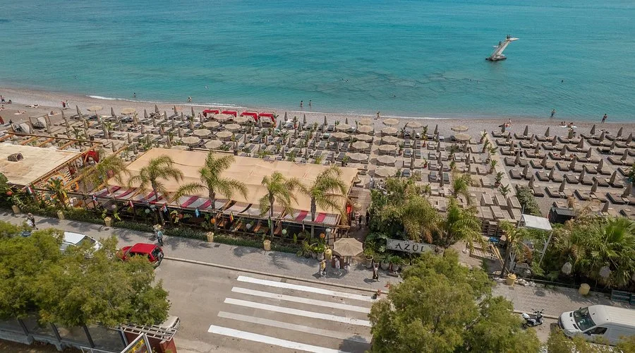 Latin-themed beach bar and sea-facing sunbeds at Playa de Azul, northern tip of Rhodes Town