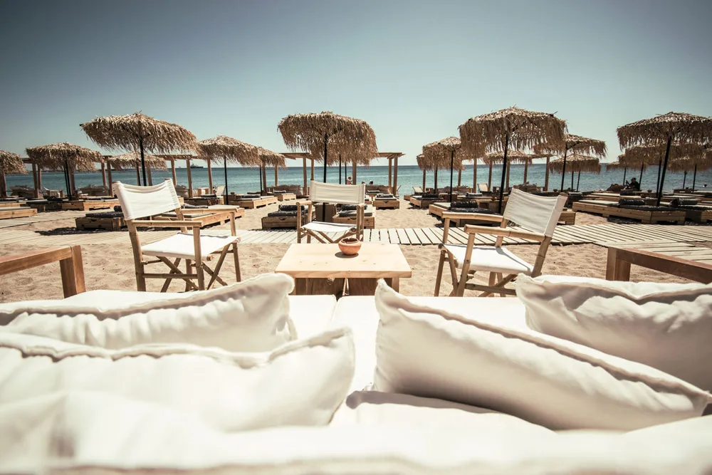 Sandy bay loungers and luxury suites at Kalami Beach Bar, east coast near Kallithea