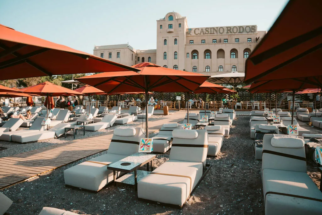 Sea-facing loungers at Grand Beach on the Rhodes Town waterfront