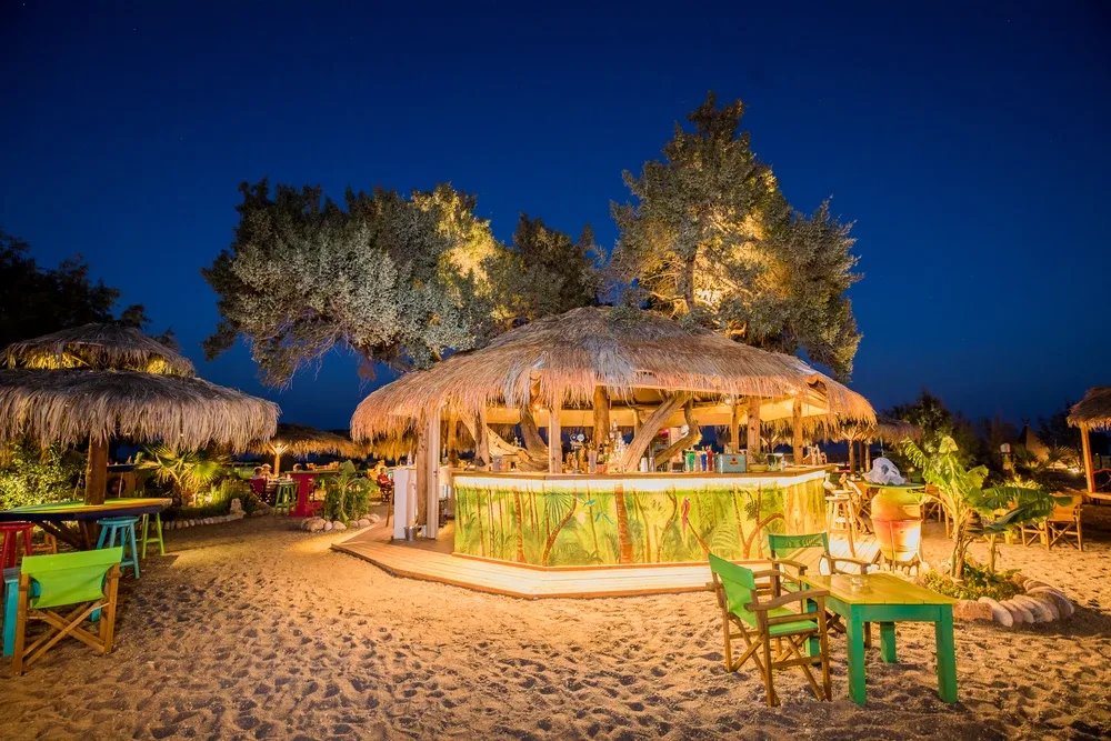 Tiki bar and beachfront loungers at Mojito Beach Bar, Lahania on the south coast