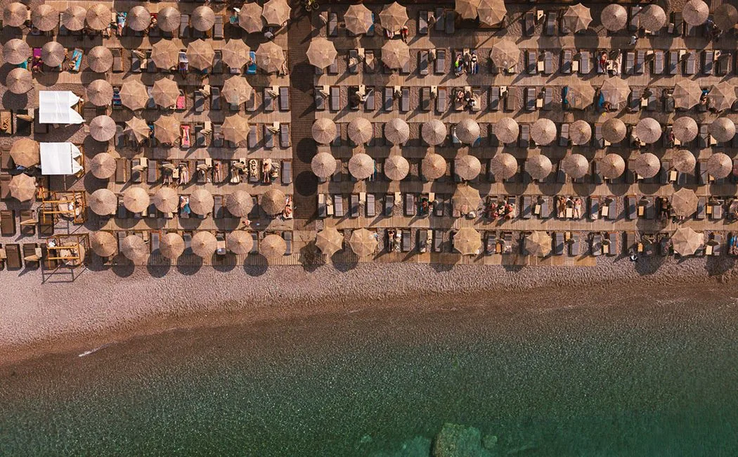 White-and-wood loungers in a quiet bay at Baia Seaside, beside the Old Town, Rhodes