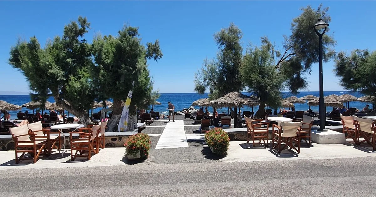All-day lounging on the black sand at The Beach Bar, Perissa Beach